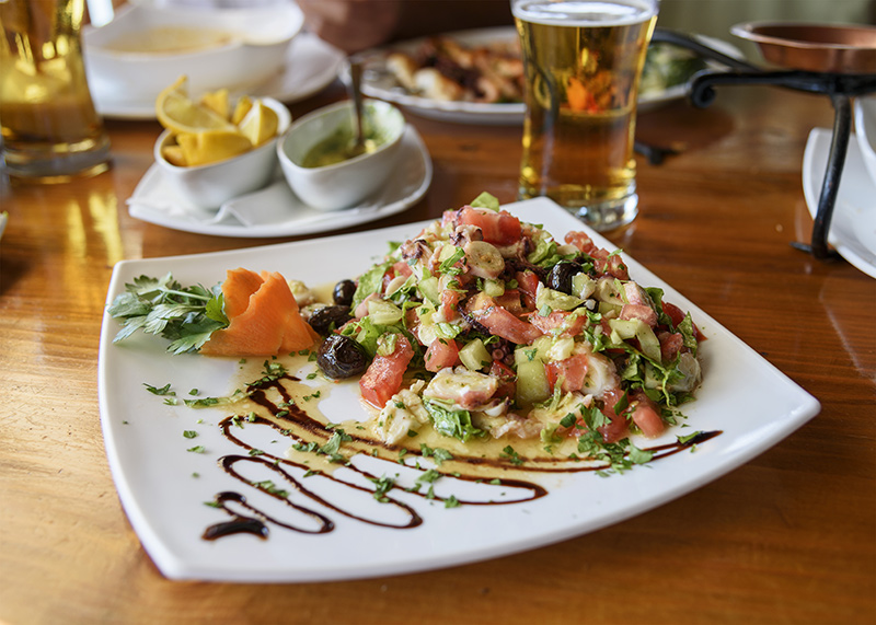 Fresh vegetable salad with octopus.